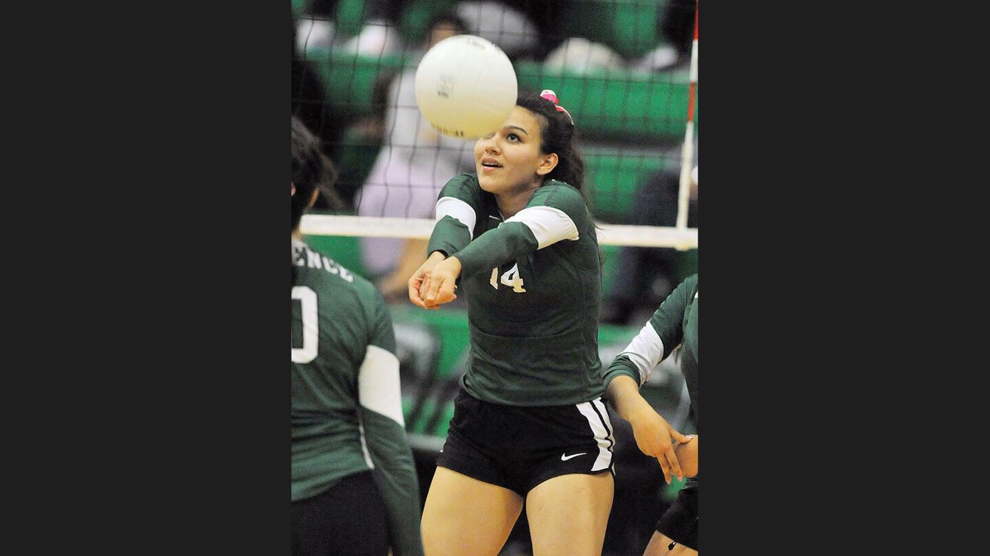 Providence's Alyssa Suarez hits the ball into play at the net against Archer in Liberty League girls' volleyball match at Providence High School on Tuesday, October 18, 2016.