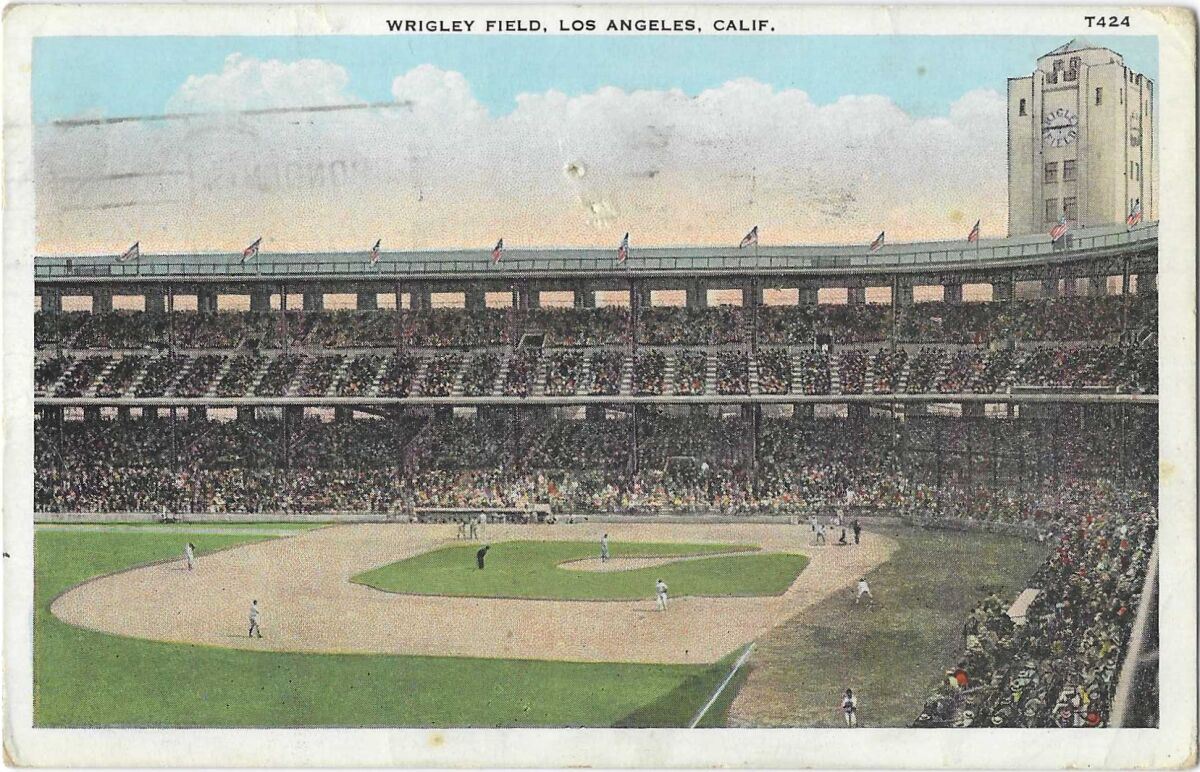 An interior view of L.A.'s Wrigley Field shows packed stands, players on the field and the stadium clock tower.