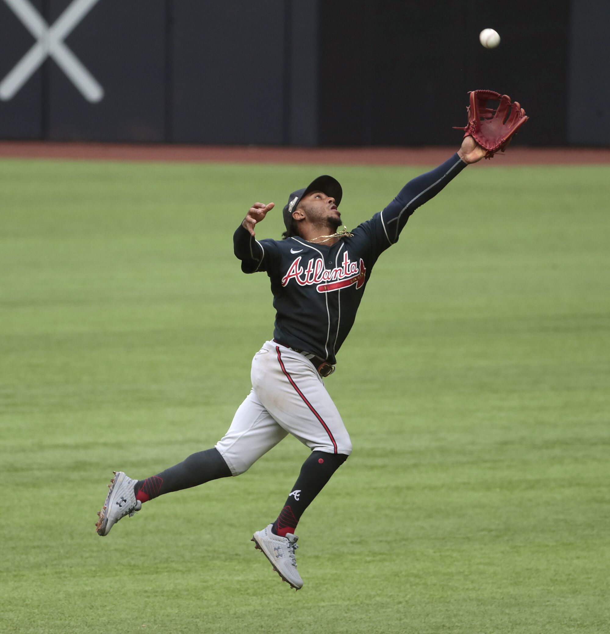  Atlanta Braves second baseman Ozzie Albies can't reach a fourth inning single by   Dodgers catcher Austin Barnes.