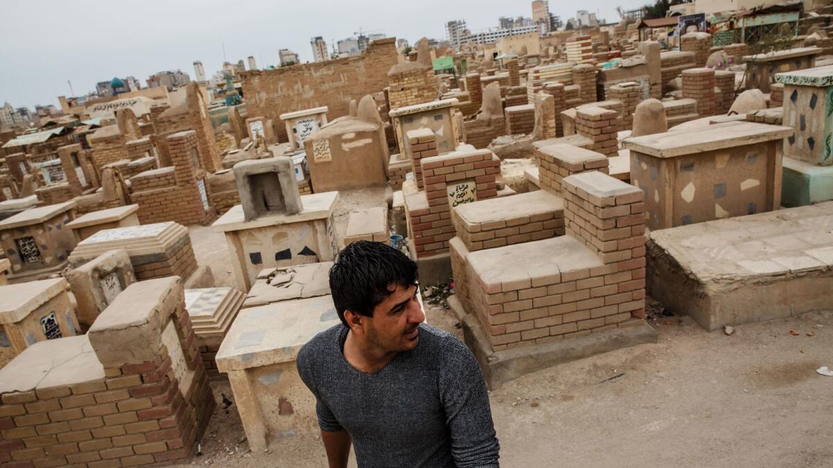 Wissam Daoud visits the holy city of Najaf to pray at a burial ground full of Shiite Muslim comrades who died fighting Islamic State. (Marcus Yam / Los Angeles Times)