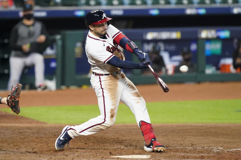 Atlanta Braves' Travis d'Arnaud hits a three-run home run during the seventh inning in Game 1 of a baseball National League Division Series against the Miami Marlins Tuesday, Oct. 6, 2020, in Houston. (AP Photo/Eric Gay)