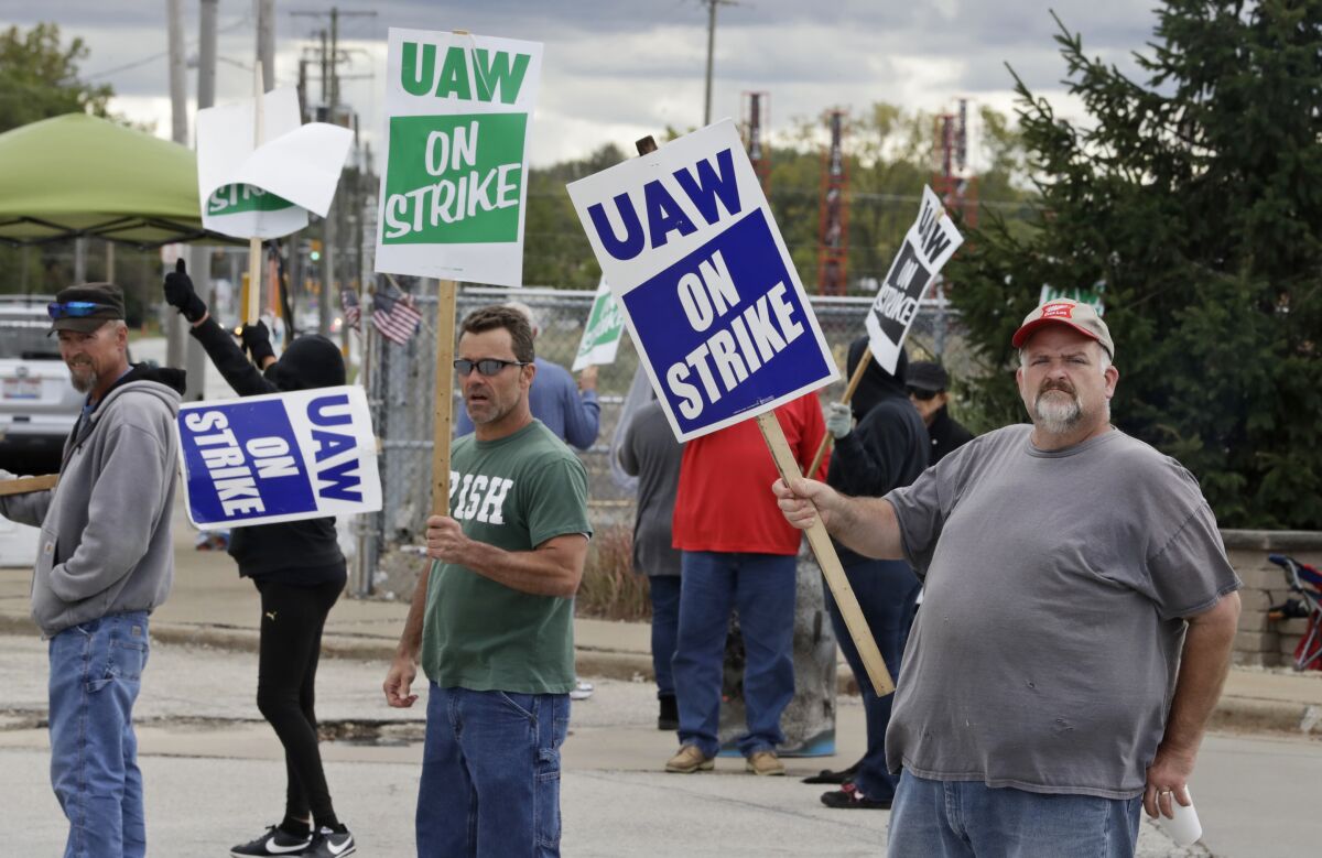 GM worker John Kirk, right, and other picketers in Parma, Ohio