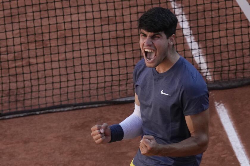 Spain's Carlos Alcaraz celebrates as he won the semifinal match of the French Open tennis tournament against Italy's Jannik Sinner at the Roland Garros stadium in Paris, Friday, June 7, 2024. (AP Photo/Christophe Ena)