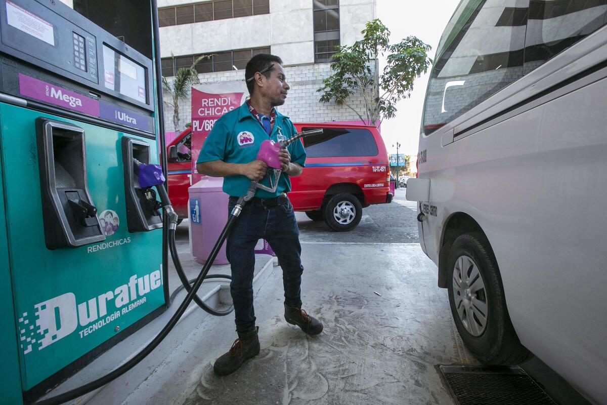 At the Rendichicas service station in Tijuana, maintenance worker Jorge Sanchez Garcia, who is a maintenance worker at the station, was doing work usually done by an all-women staff who stayed home on Monday.