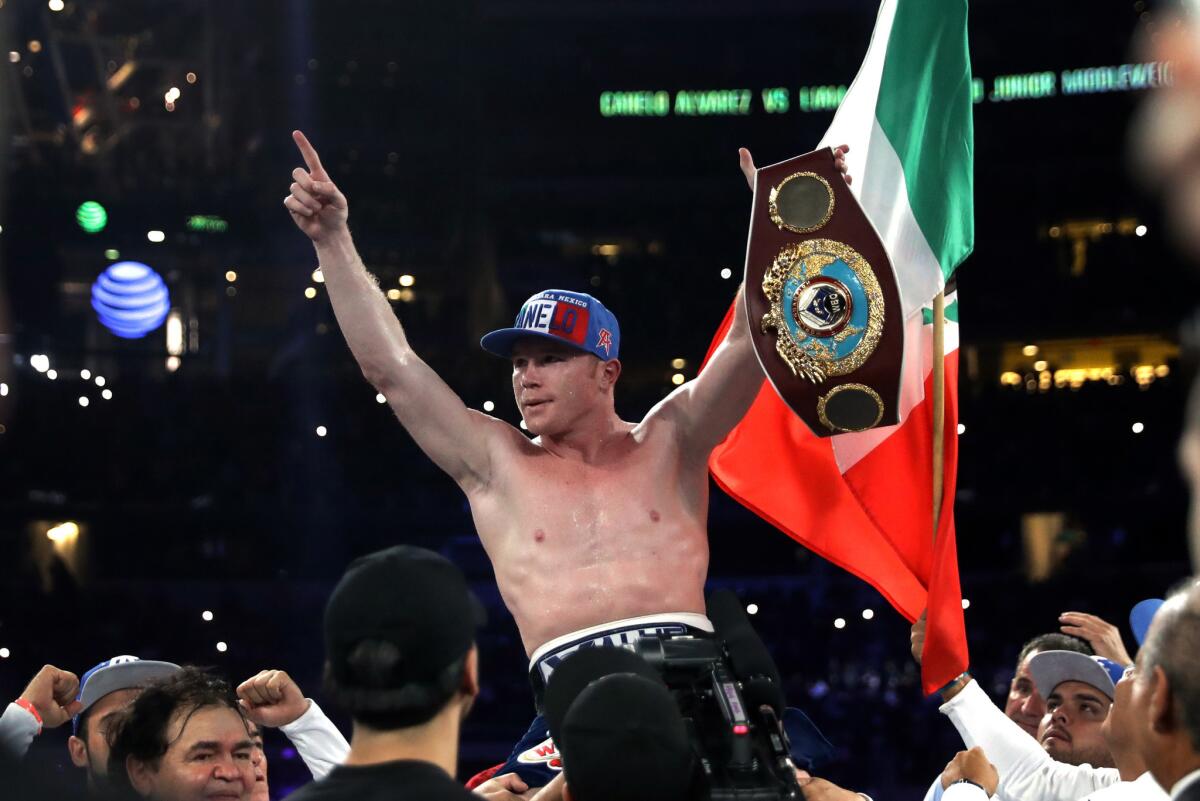 Canelo Alvarez celebrates after knocking out Liam Smith during a Word Boxing Organization junior-middleweight title fight at AT&T Stadium on Sept. 17 in Arlington, Texas.
