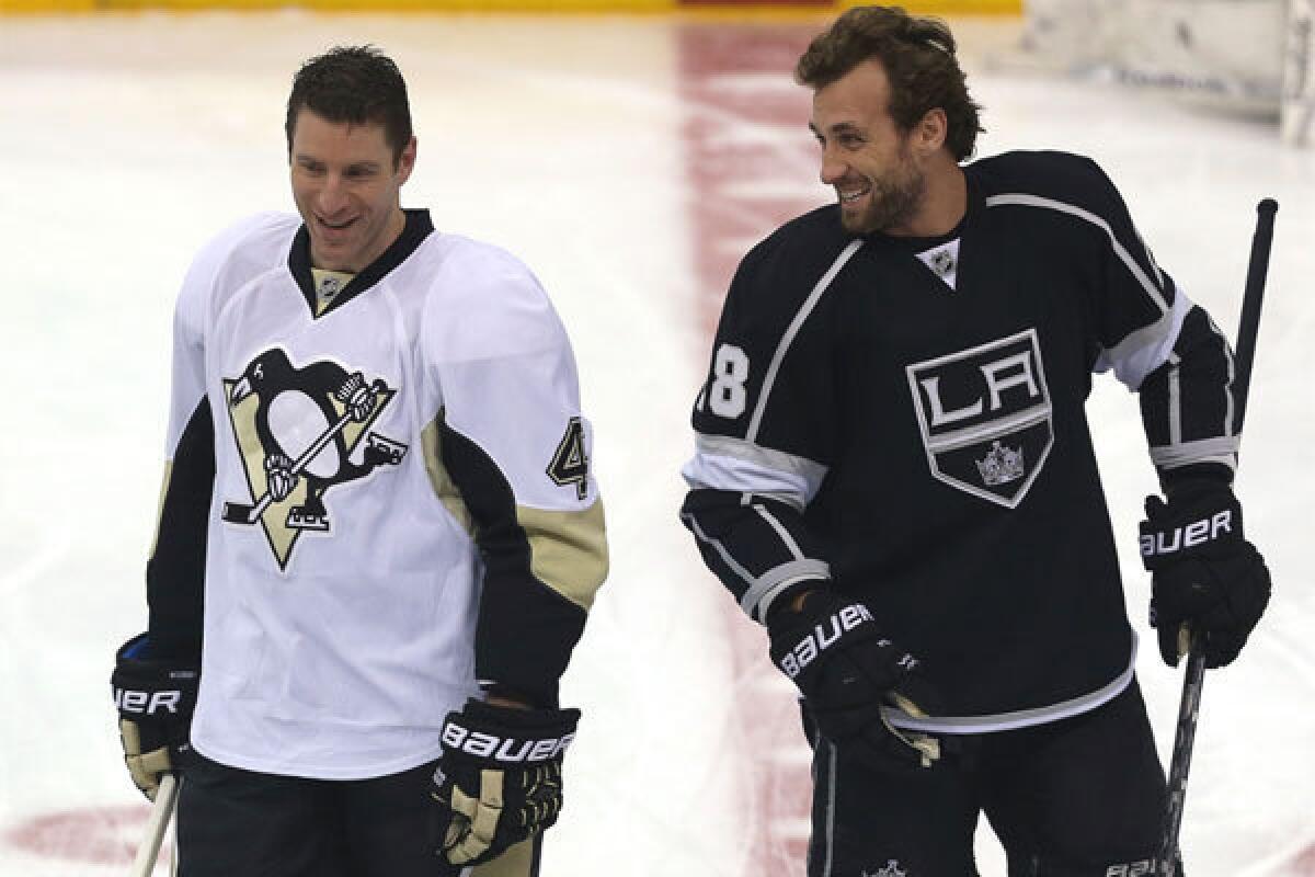 Former Kings teammates Rob Scuderi, left, now with the Pittsburgh Penguins, and Jarret Stoll share a laugh before the teams' Jan. 30 game at Staples Center.