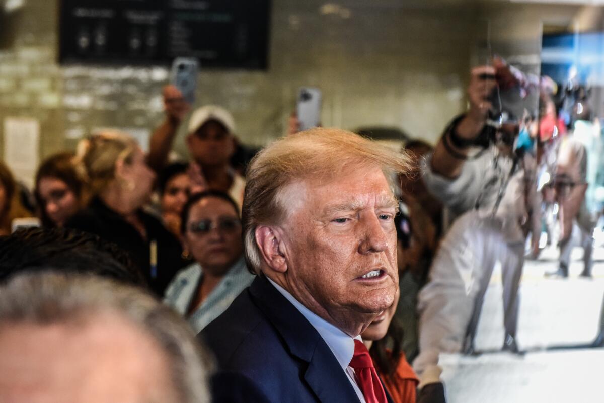 Former President Trump grimaces while at a restaurant in Miami