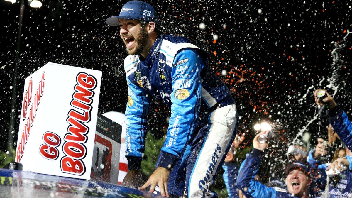 NASCAR driver Martin Truex Jr. celebrates in Victory Lane after winning the Monster Energy NASCAR Cup Series Go Bowling 400 at Kansas Speedway on Saturday night.