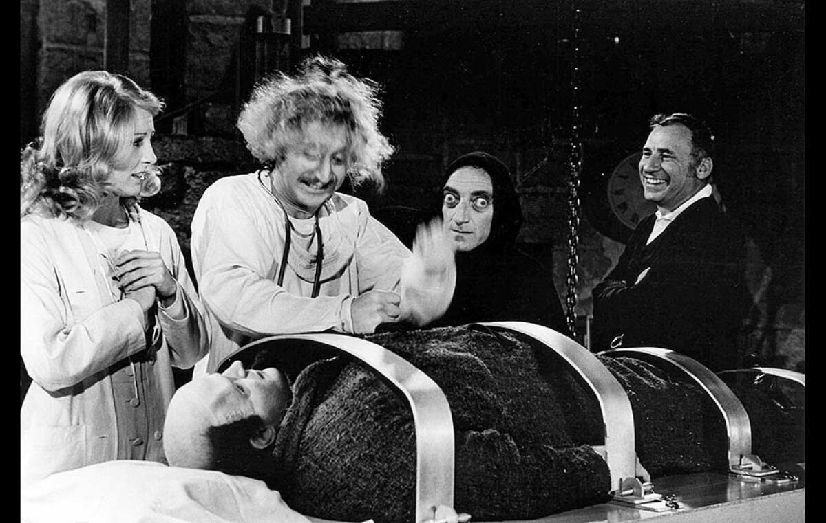 Director Mel Brooks, right, looks on as Teri Garr, Gene Wilder and Marty Feldman, with Peter Boyle as the monster, re-create a scene from “Young Frankenstein” for a Los Angeles Times photographer.