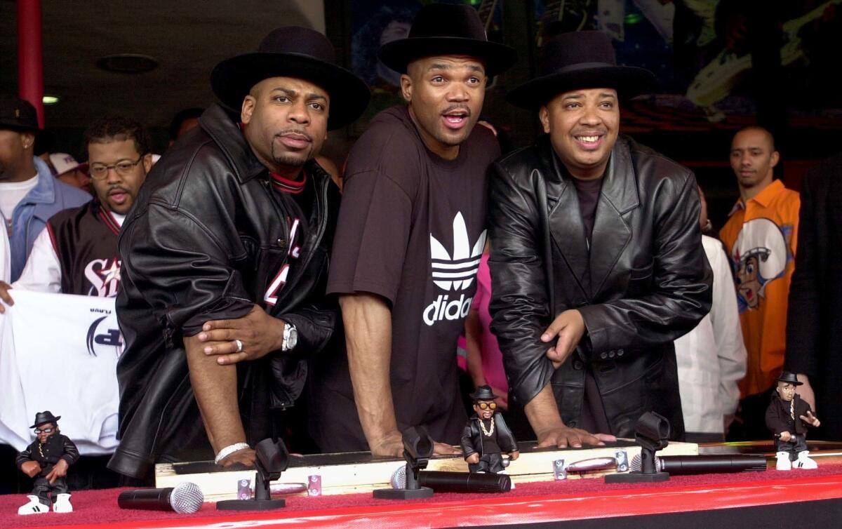 Jason "Jam Master Jay" Mizell, from left, Darryl "DMC" McDaniels and Joseph "DJ Run" Simmons of Run-DMC being inducted into Hollywood's RockWalk on Feb. 25, 2002, in L.A. The trio signed a $1 million deal with Adidas, considered hip-hop's first endorsement deal.