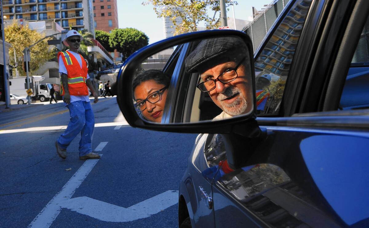 Steve Lopez, moonlighting as an Uber driver, with his first customer, Eloisa Lopez.