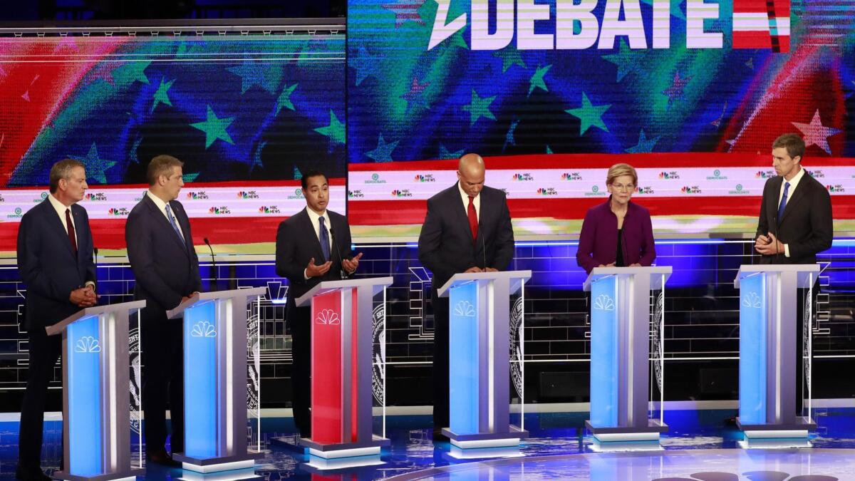 Democratic presidential candidates listen to a question during the Democratic primary debate hosted by NBC News in Miami on June 26.
