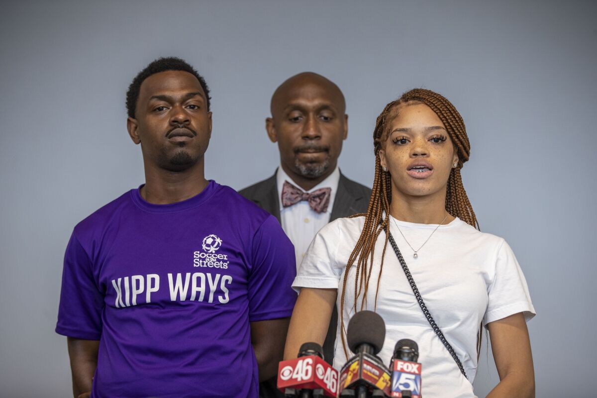 FILE - In this June 7, 2021, file photo, attorney Mawuli Davis, center, stands with his clients, Charmaine Turner, right, and Secoriey Williamson, parents of Secoriea Turner, as they speak during a press conference to announce a lawsuit against the city of Atlanta and others for a series of actions that resulted in the death of their 8-year-old daughter. The parents of Secoriea, an 8-year-old girl who was shot and killed near the site where Rayshard Brooks had been shot several weeks earlier, said Tuesday, Aug. 10, 2021, they're encouraged by the progress of the investigation after meeting with the district attorney whose office will prosecute the case. (Alyssa Pointer/Atlanta Journal-Constitution via AP, File)