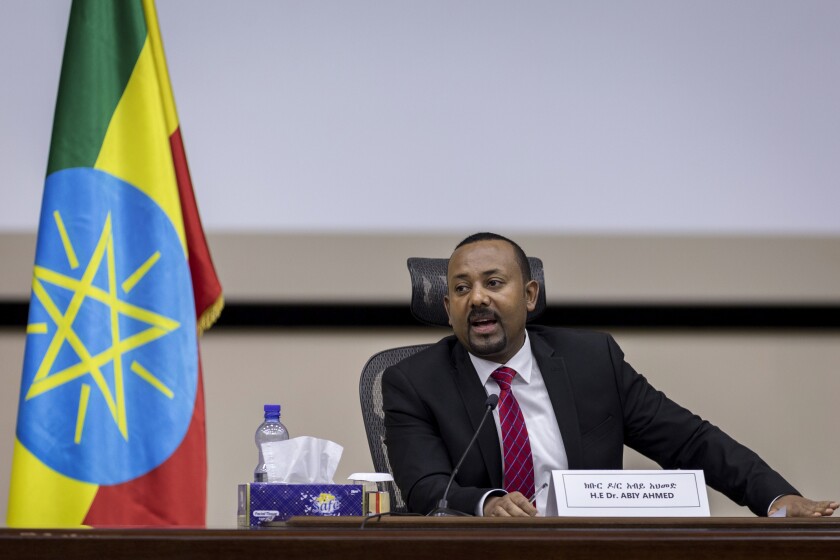 FILE - In this file photo dated Monday, Nov. 30, 2020, Ethiopia's Prime Minister Abiy Ahmed responds to questions from members of parliament at the prime minister's office in the capital Addis Ababa, Ethiopia. A new report from the Ethiopian Human Rights Commission published Friday Jan. 1, 2021, says Ethiopian security forces killed more than 75 people and injured nearly 200 during deadly unrest in June and July after the killing of a popular singer. Ethnic violence is a major challenge to Nobel Peace Prize-winning Prime Minister Abiy Ahmed, who has urged national unity. (AP Photo/Mulugeta Ayene, FILE)
