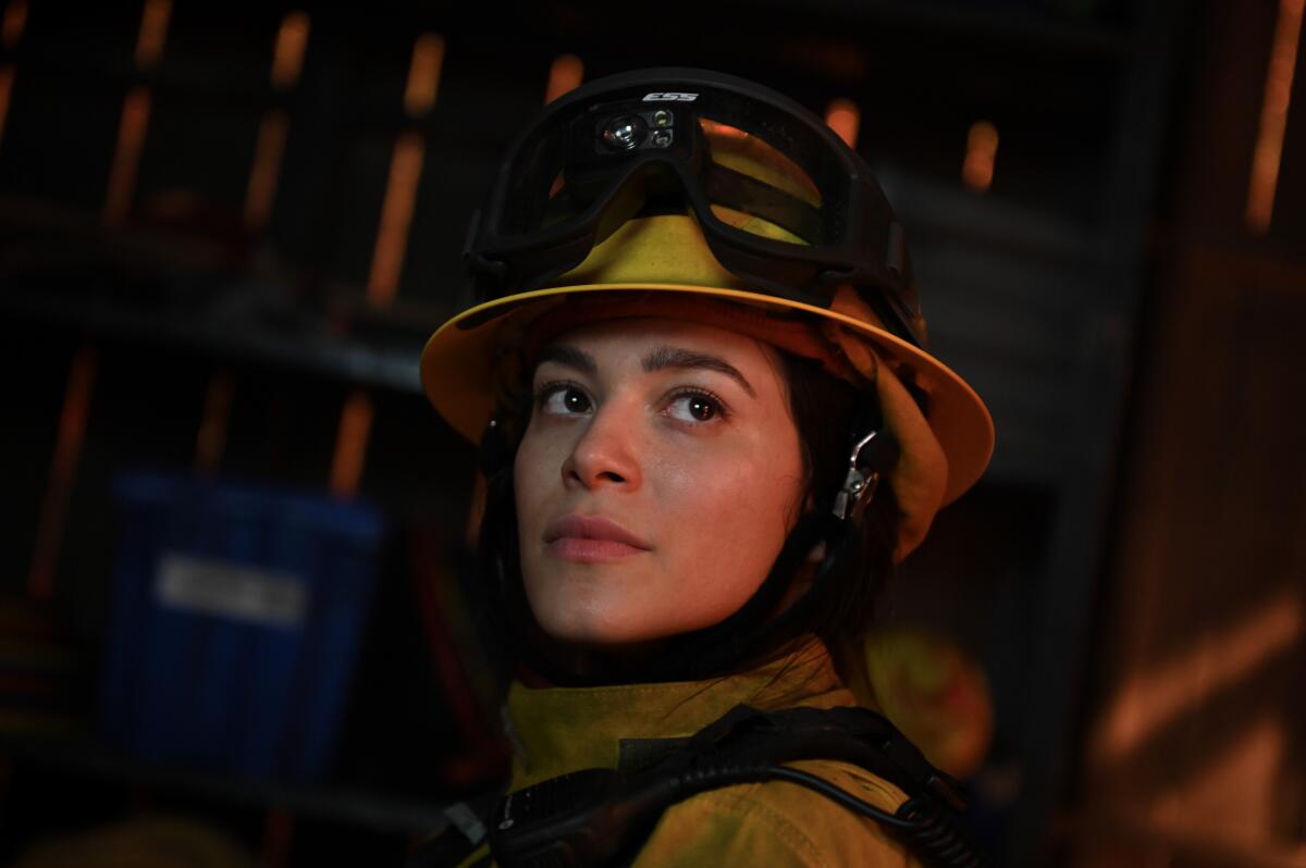 A close-up of a woman firefighter.
