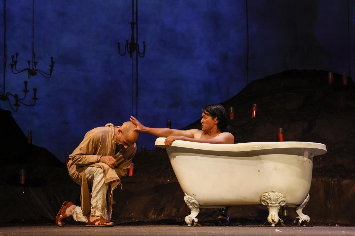 Ogie Zulueta, right, and Daniel Duque-Estrada perform a scene from the Latino Theater Company production of "The Travelers"