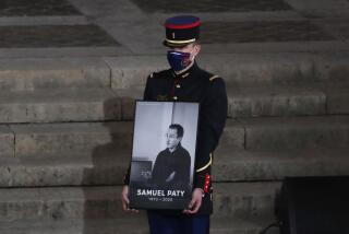 A Republican Guard holds a portrait of Samuel Paty in the courtyard of the Sorbonne university during a national memorial event, Wednesday, Oct. 21, 2020 in Paris. A French juvenile court is handing down a verdict Friday Dec.8, 2023 for six teenagers accused of involvement in the killing of teacher Samuel Paty, beheaded by an Islamic extremist after he showed caricatures of the Prophet Muhammad to his class for a debate on freedom of expression. (AP Photo/Francois Mori, Pool, File)