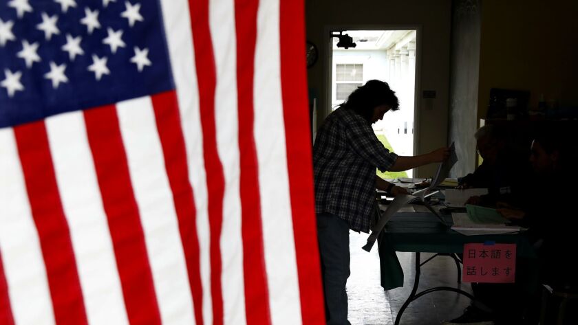 A voter checks in at a polling place at First Christian Church in Torrance on Tuesday. Democrats must flip 23 seats to take over the House and California remains central to that nationwide effort.