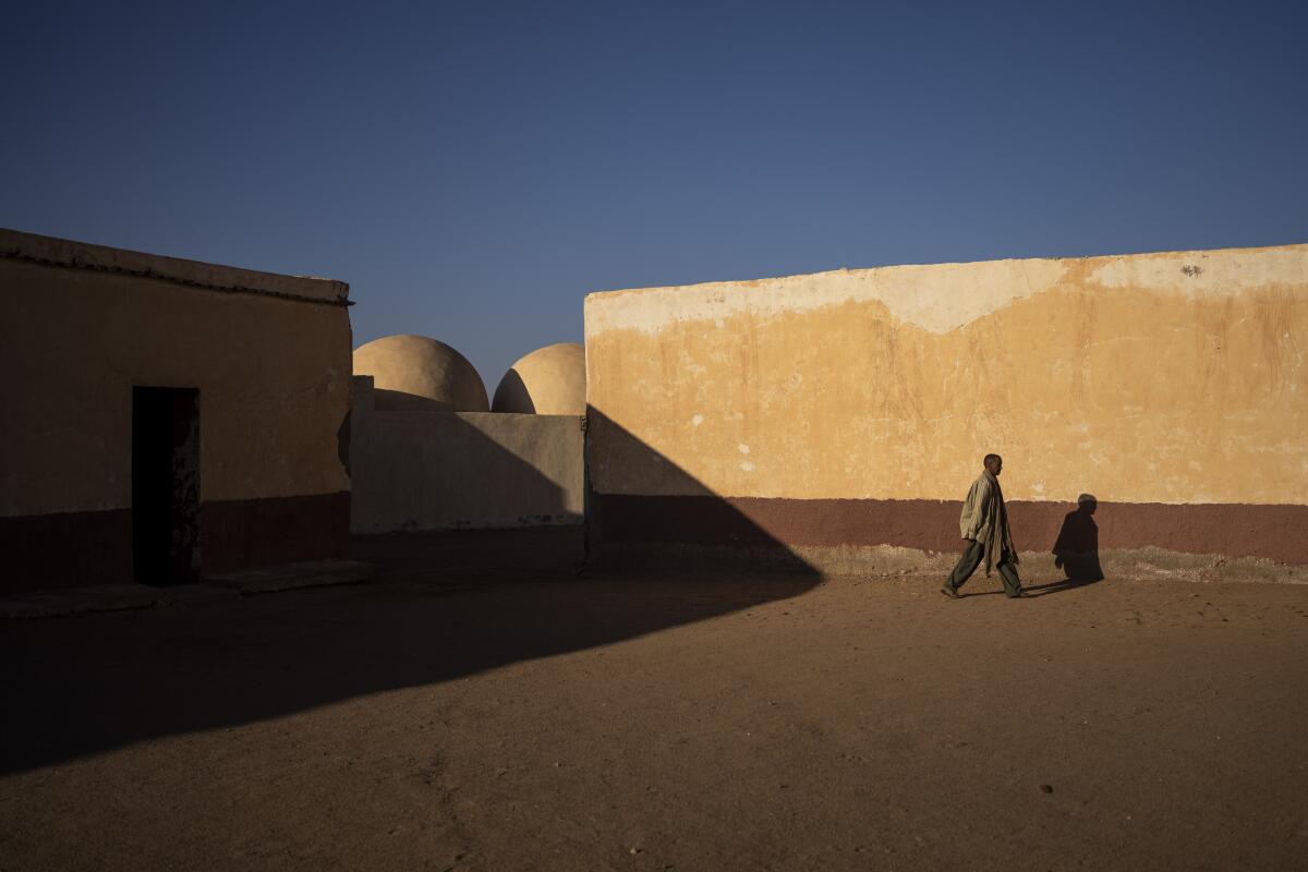A Sahrawi man walks on the patio of a closed school in Bir Lahlou, Western Sahara.