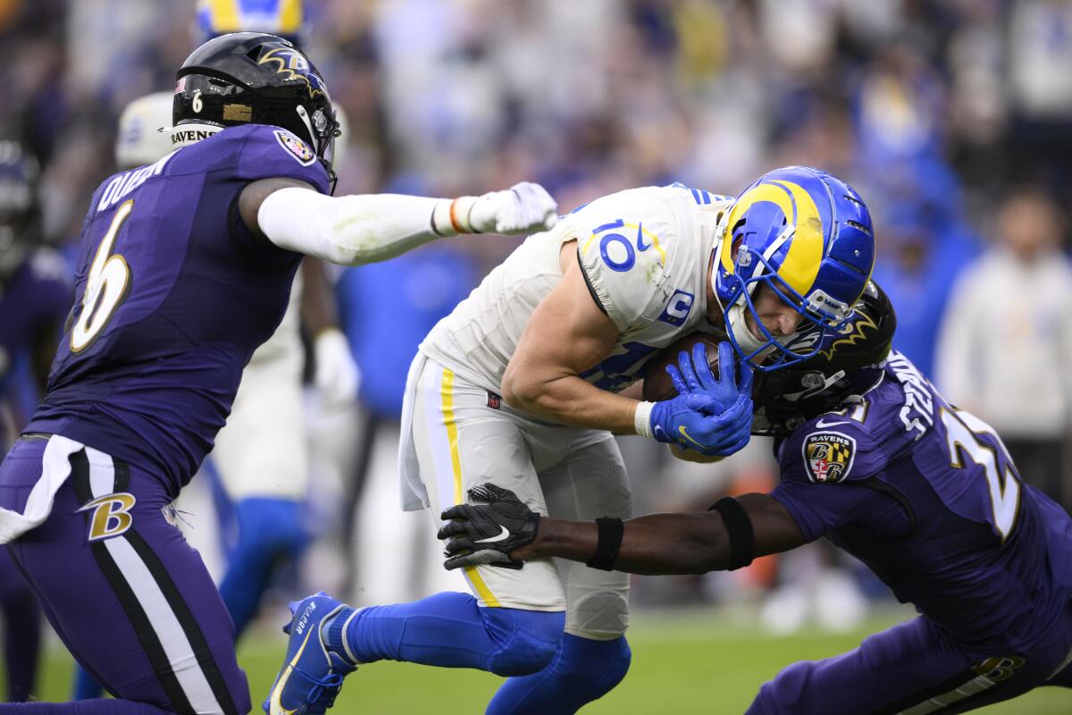 Rams' Cooper Kupp scores a touchdown as Baltimore Ravens' Brandon Stephens and Patrick Queen try to stop him.
