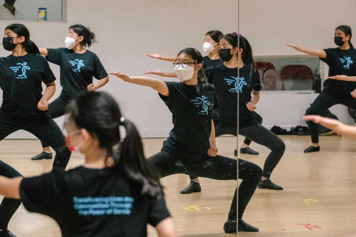 girls reflected dancing in the mirrors of a dance studio 