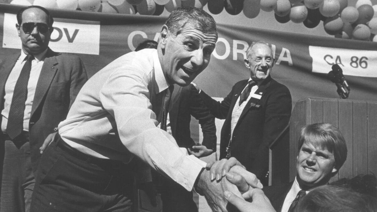 Gov. George Deukmejian shakes hands with supporters on Nov. 2, 1986.