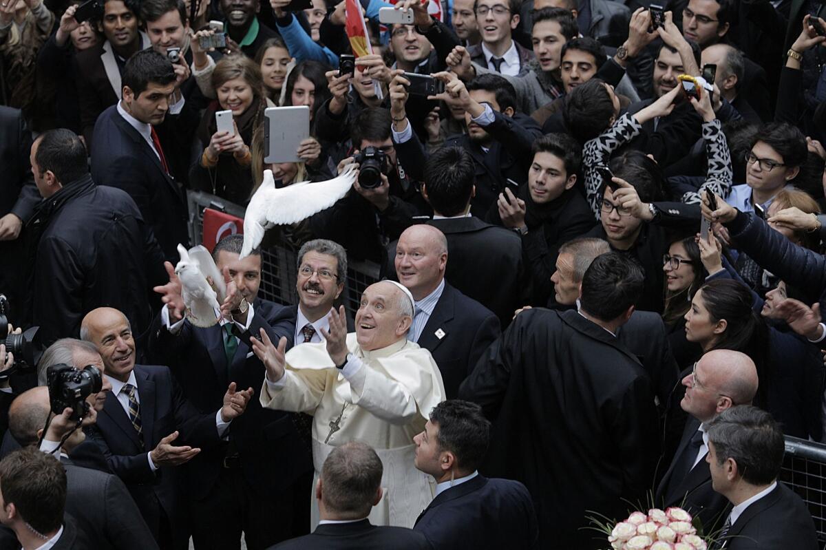 Pope Francis frees a dove upon arrival at the Istanbul's St. Esprit Cathedral on Nov. 29.