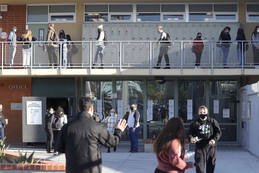 Students return to Costa Mesa High school on the first day back to school for secondary students in the Newport-Mesa Unified School District on Monday.