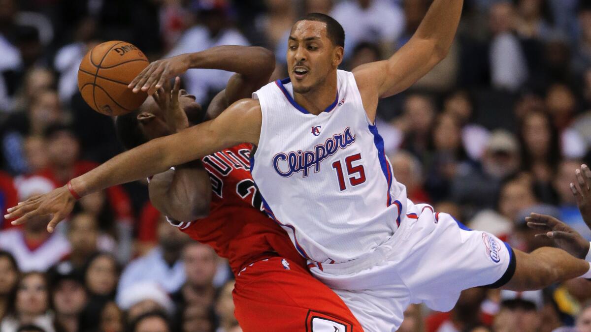 Clippers center Ryan Hollins, right, fouls Chicago Bulls guard Jimmy Butler during a game in November 2012.
