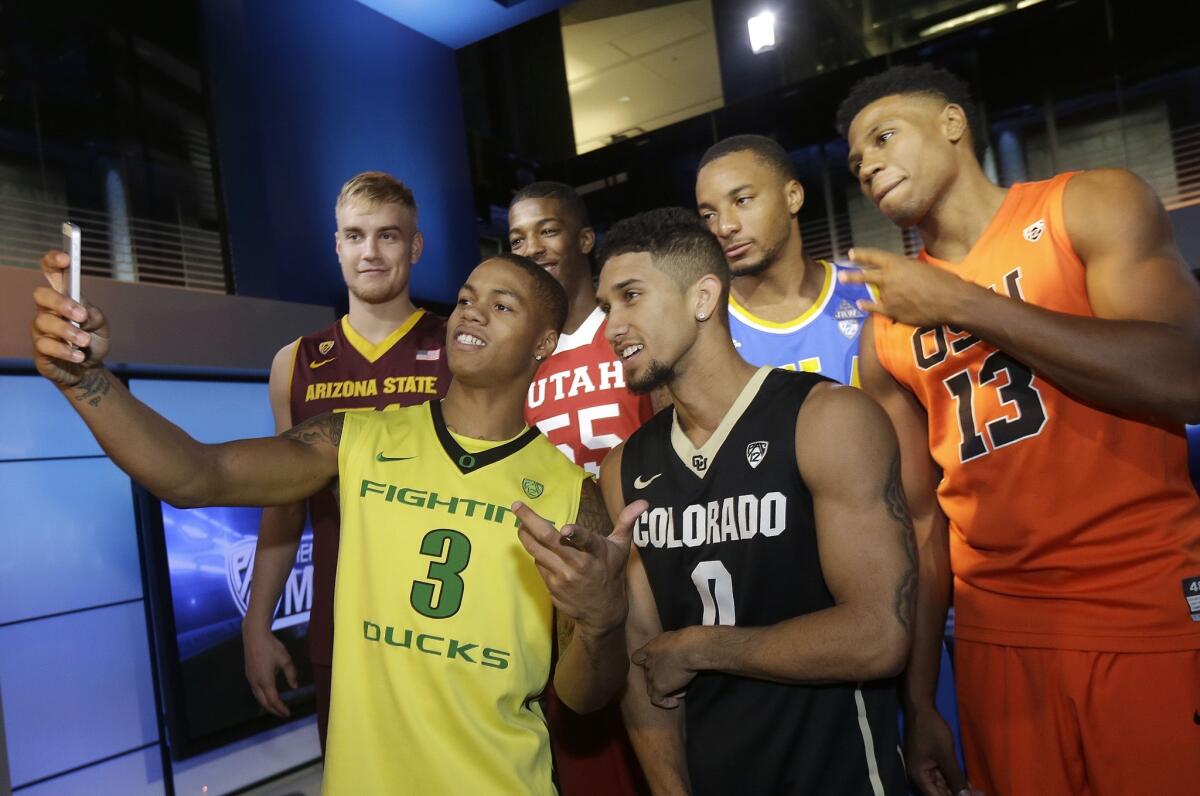 Oregon's Joseph Young (3) takes a picture with Colorado's Askia Booker (0), Oregon State's Langston Morris-Walker (13), Arizona State's Jonathan Gilling, Utah's Delon Wright and UCLA's Norman Powell.