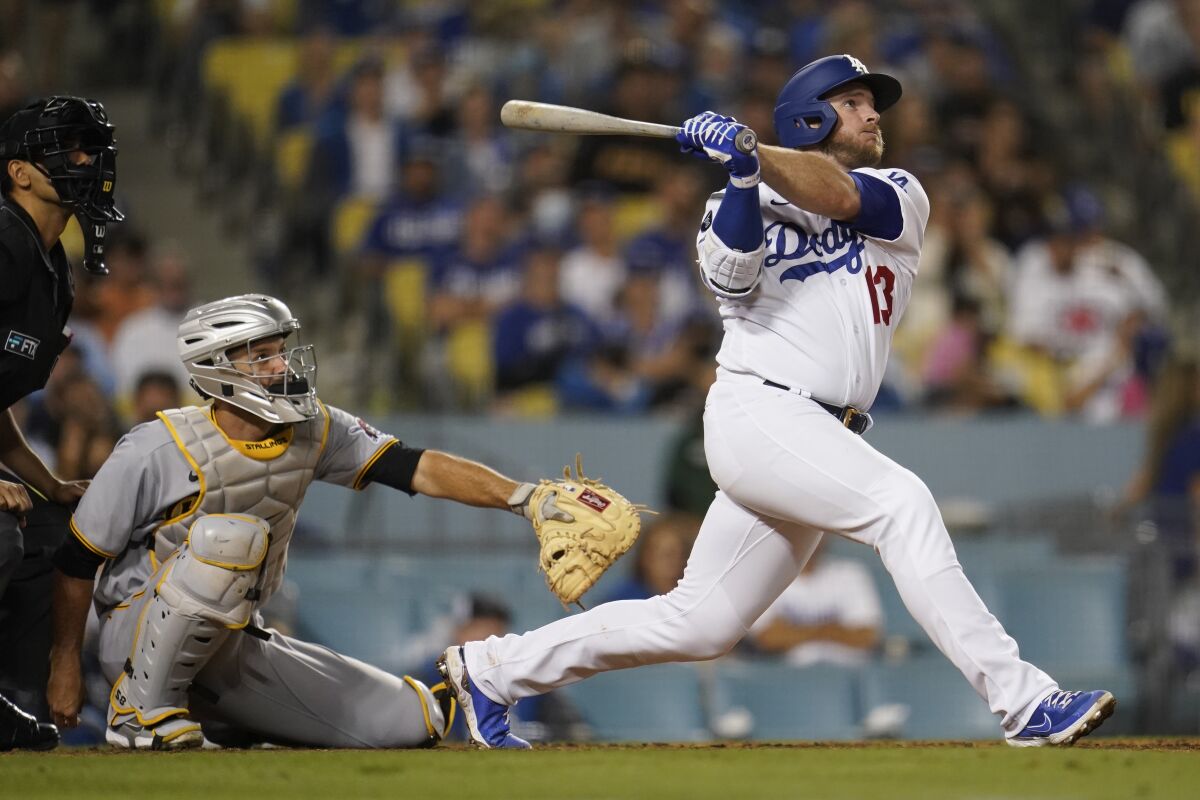 Los Angeles Dodgers' Max Muncy follows through on his solo home run during the eighth inning of a baseball game against the Pittsburgh Pirates Monday, Aug. 16, 2021, in Los Angeles. (AP Photo/Marcio Jose Sanchez)