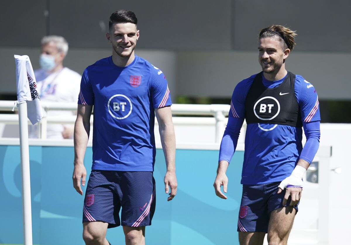 England's Declan Rice, left, and England's Jack Grealish arrive for an open training session at St. George's Park, Burton-upon-Trent, Wednesday June 9, 2021. The Euro 2020 soccer championship gets underway on Friday June 11 and is being played in 11 host cities across 11 countries. The event was delayed by one year after being postponed in 2020 due to the COVID-19 pandemic. (AP Photo/Dave Thompson)