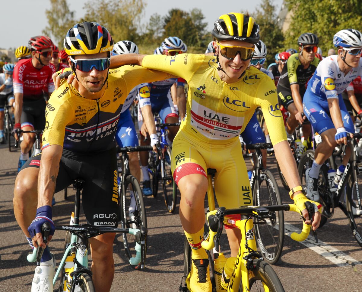 Primoz Roglic gets a hug during the 21st and last stage of the Tour de France.