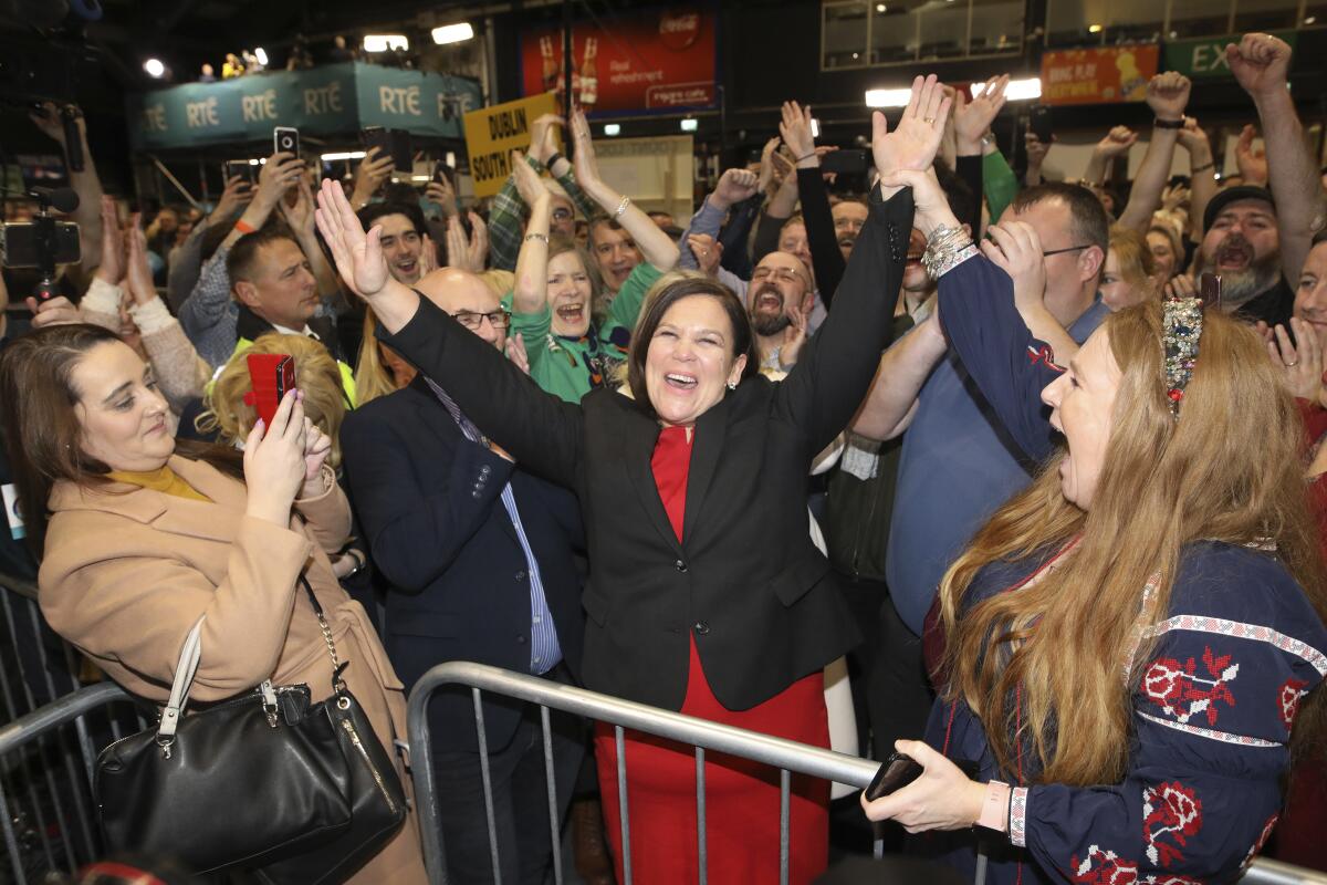 Sinn Fein leader Mary Lou McDonald, center, and supporters celebrate election results in Dublin on Sunday.
