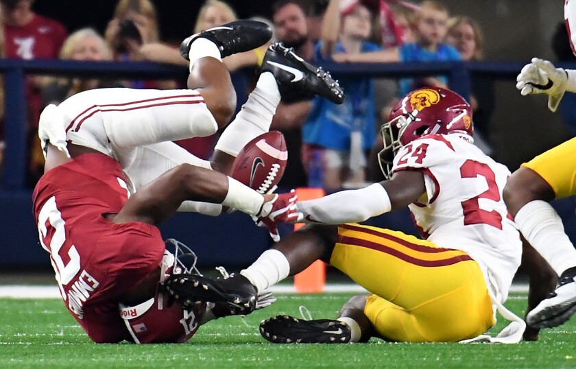 USC defensive back John Platterburg upends Alabama running back B.J. Emmons during the season opener. Many Trojans said they plan to bring more intensity to the game Saturday against Utah State.