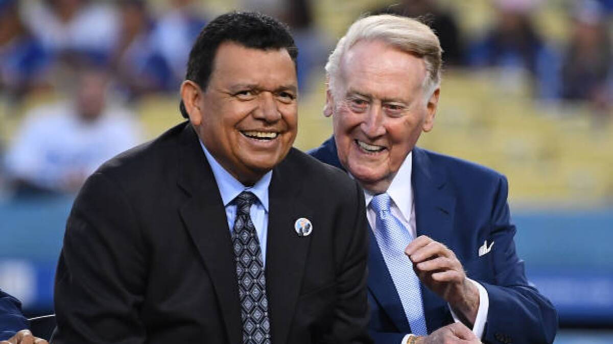 Vin Scully, right, talks with Fernando Valenzuela during a ceremony at Dodger Stadium in 2018. 