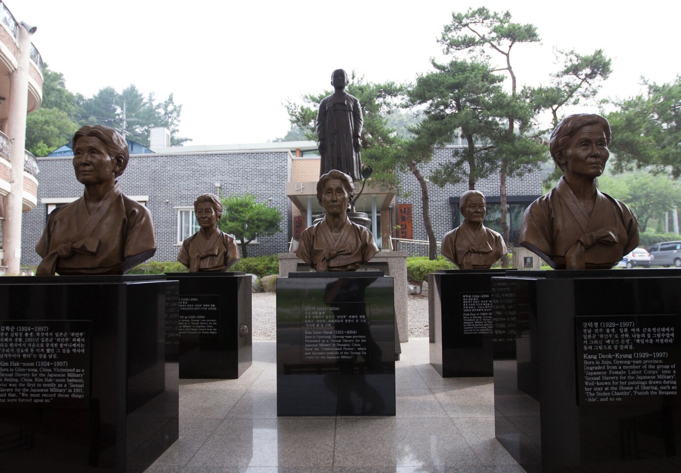 Bronze busts of "comfort women," who spent World War II in Japanese military brothels, cover a portion of the courtyard at "The House of Sharing" in Seoul. Details about each woman and her plight are engraved in marble.