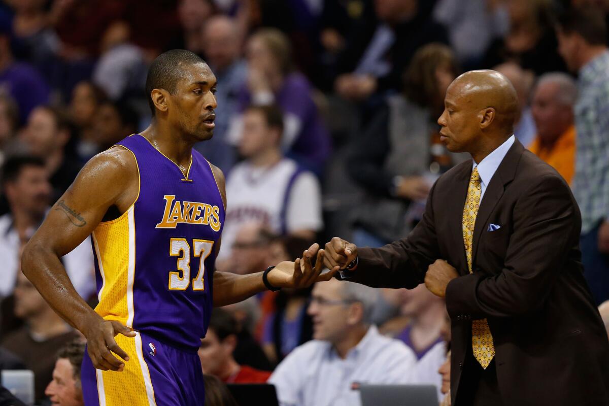 Lakers forward Metta World Peace high-fives Coach Byron Scott as he checks out during the first half.