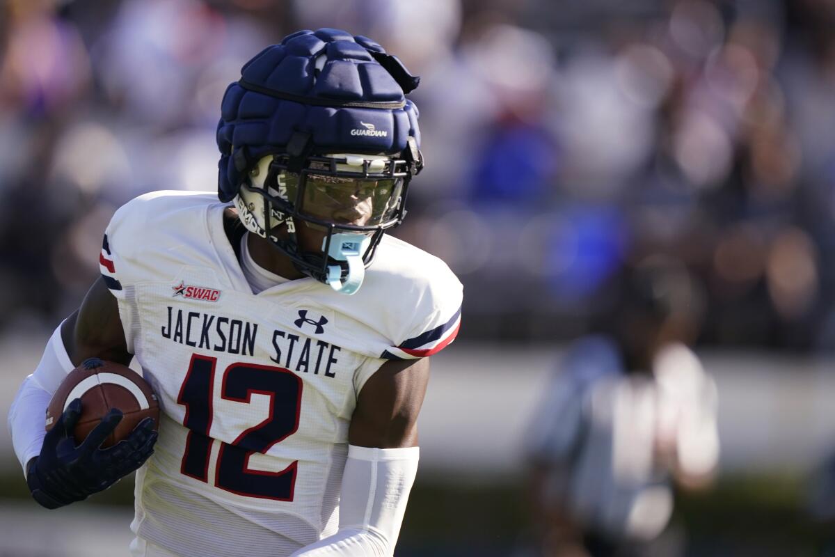 FILE - Travis Hunter (12) catches a pass in the first half of Jackson State's spring football game April 24, 2022, in Jackson, Miss. Hunter was likely the most talked about recruit in the 2022 class, if not before signing day, certainly after when he opted to play at Jackson State. The two-way player from Suwanee, Ga., became the first five-star recruit to sign with an FCS school since the ratings system was developed, and the first to sign with a program in the Historically Black College and University ranks. (AP Photo/Rogelio V. Solis, File)