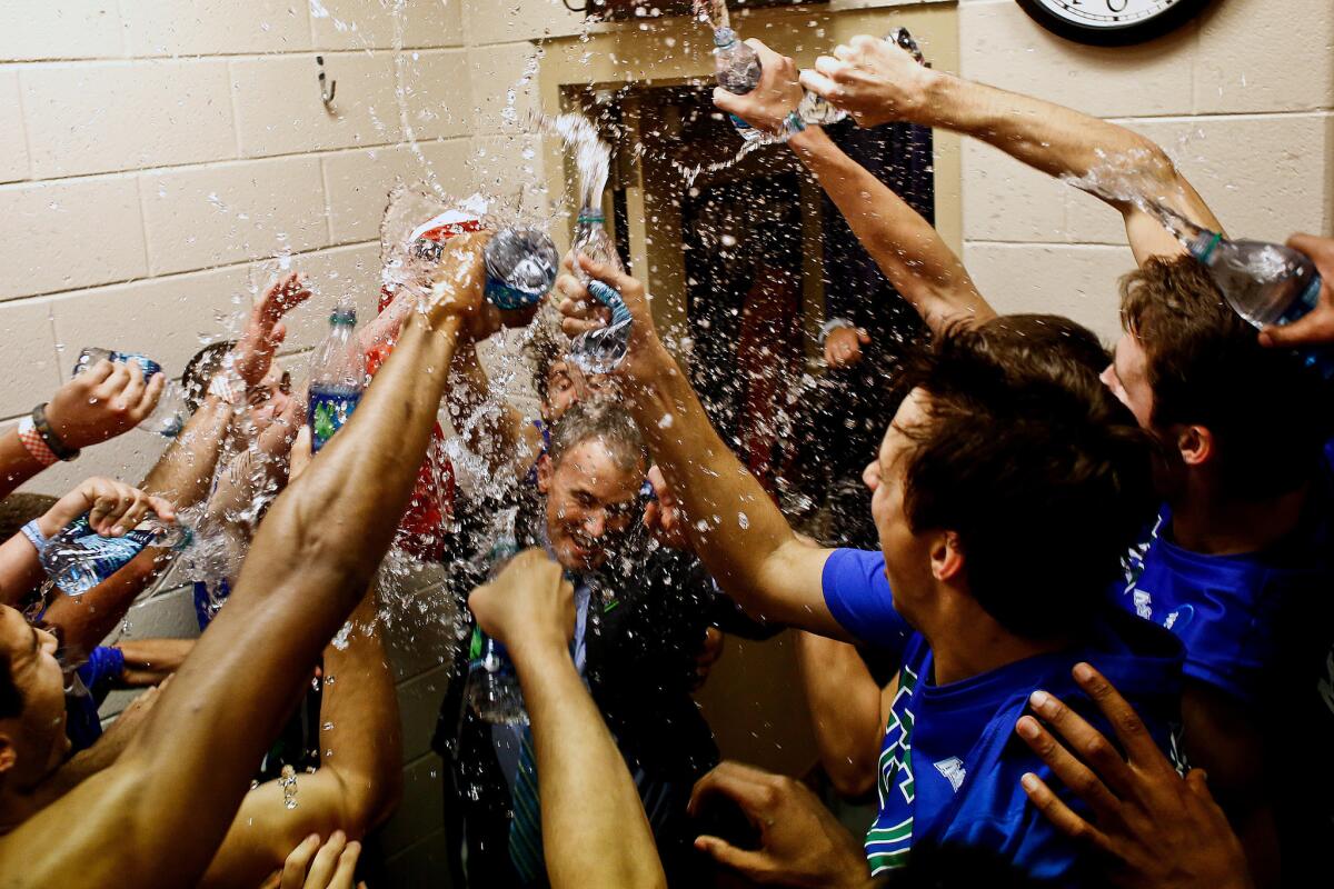 Florida Gulf Coast players shower Coach Andy Enfield with water in the team's locker room after advancing to the Sweet 16 with a win over San Diego State in the 2013 NCAA tournament.