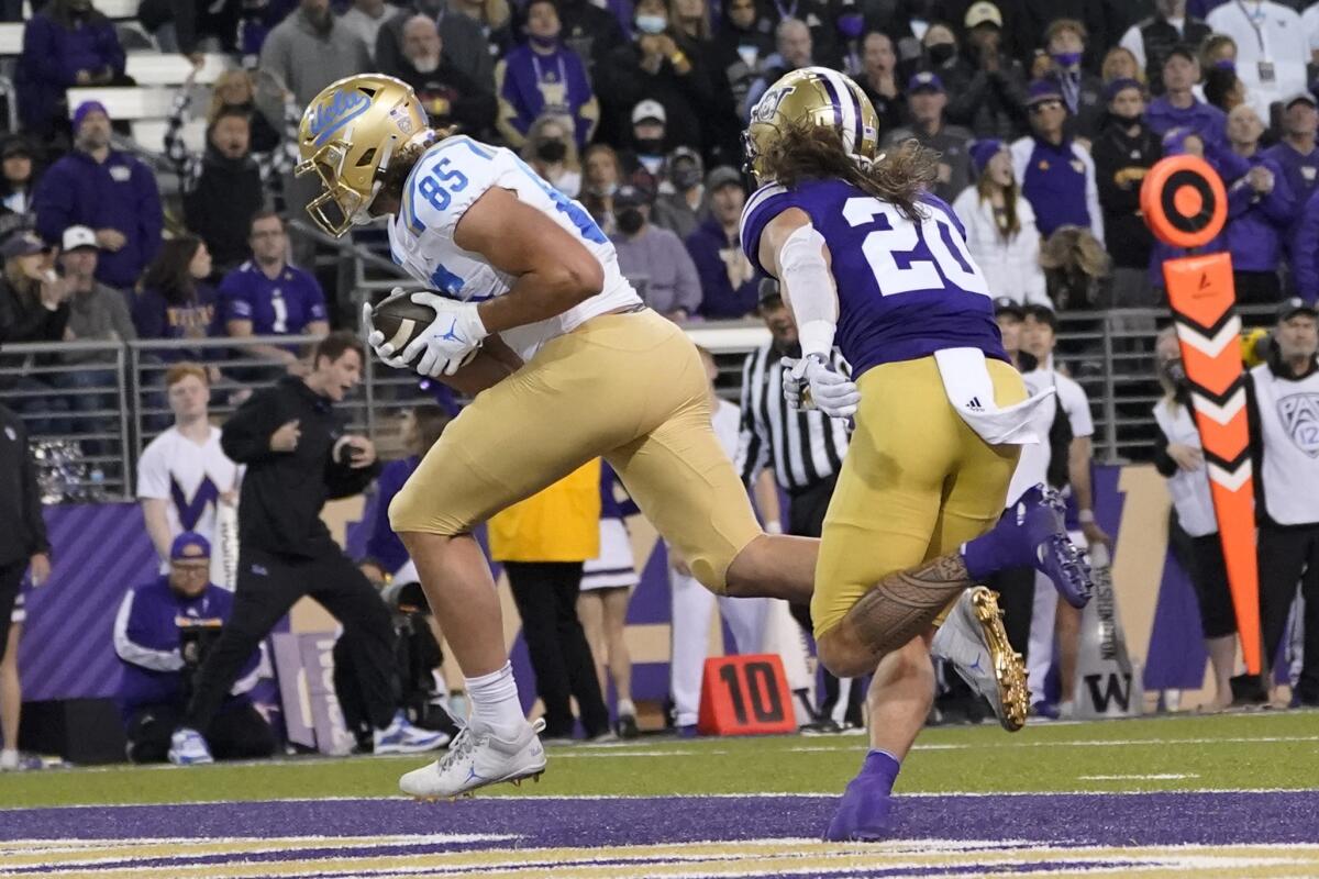 Bruins tight end Greg Dulcich gets past Washington defensive back Asa Turner on a go-ahead, nine-yard touchdown catch.