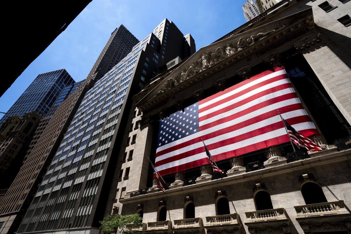 A giant U.S. flag is displayed on the facade of the New York Stock Exchange.