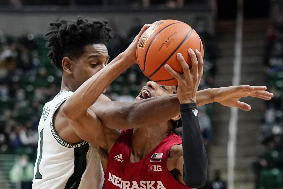 Michigan State guard A.J. Hoggard, left, fouls Nebraska guard Alonzo Verge Jr. during the first half of an NCAA college basketball game, Wednesday, Jan. 5, 2022, in East Lansing, Mich. (AP Photo/Carlos Osorio)