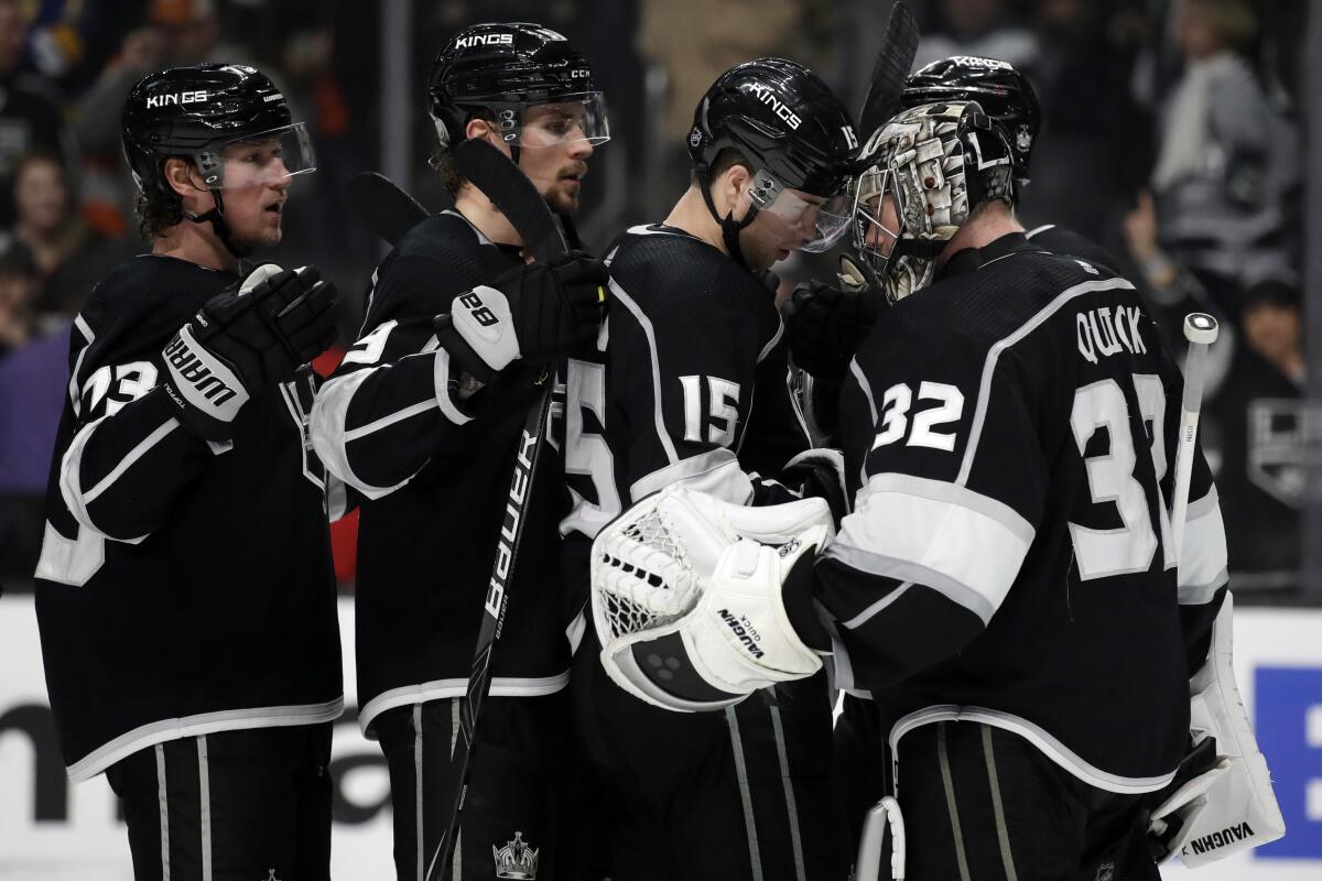 Kings goaltender Jonathan Quick (32) celebrates with teammates after a 5-3 win over the Flyers on Dec. 31 at Staples Center.