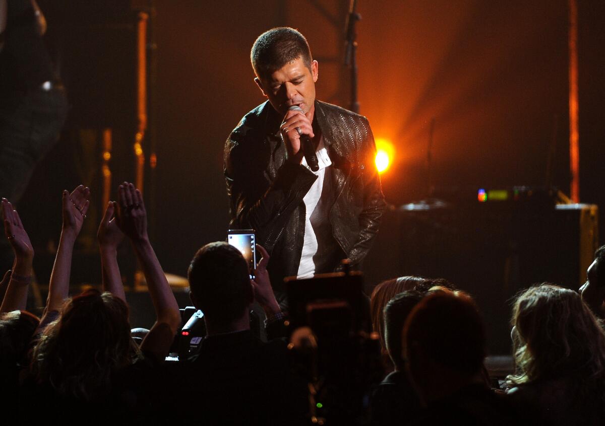 "I was high on Vicodin and alcohol when I showed up at the studio" to record "Blurred Lines" and had little to with writing the song, Robin Thicke testified in a deposition. Above, the singer onstage in Las Vegas in May.