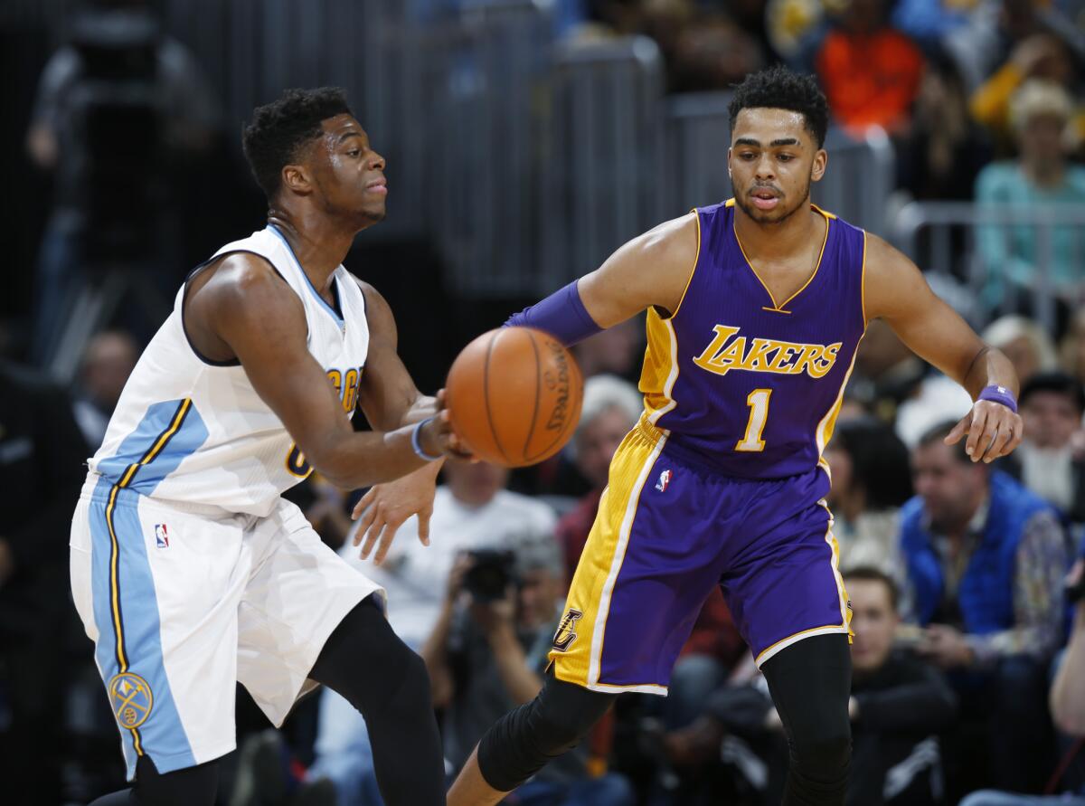 The Lakers' D'Angelo Russell defends Denver guard Emmanuel Mudiay.