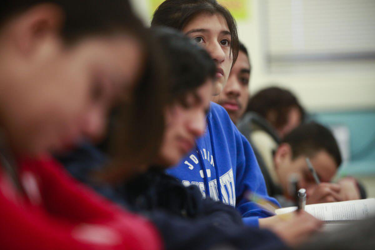 Students concentrate during an English class at Jordan High School. California officials have altered a statewide testing plan to include English and math.