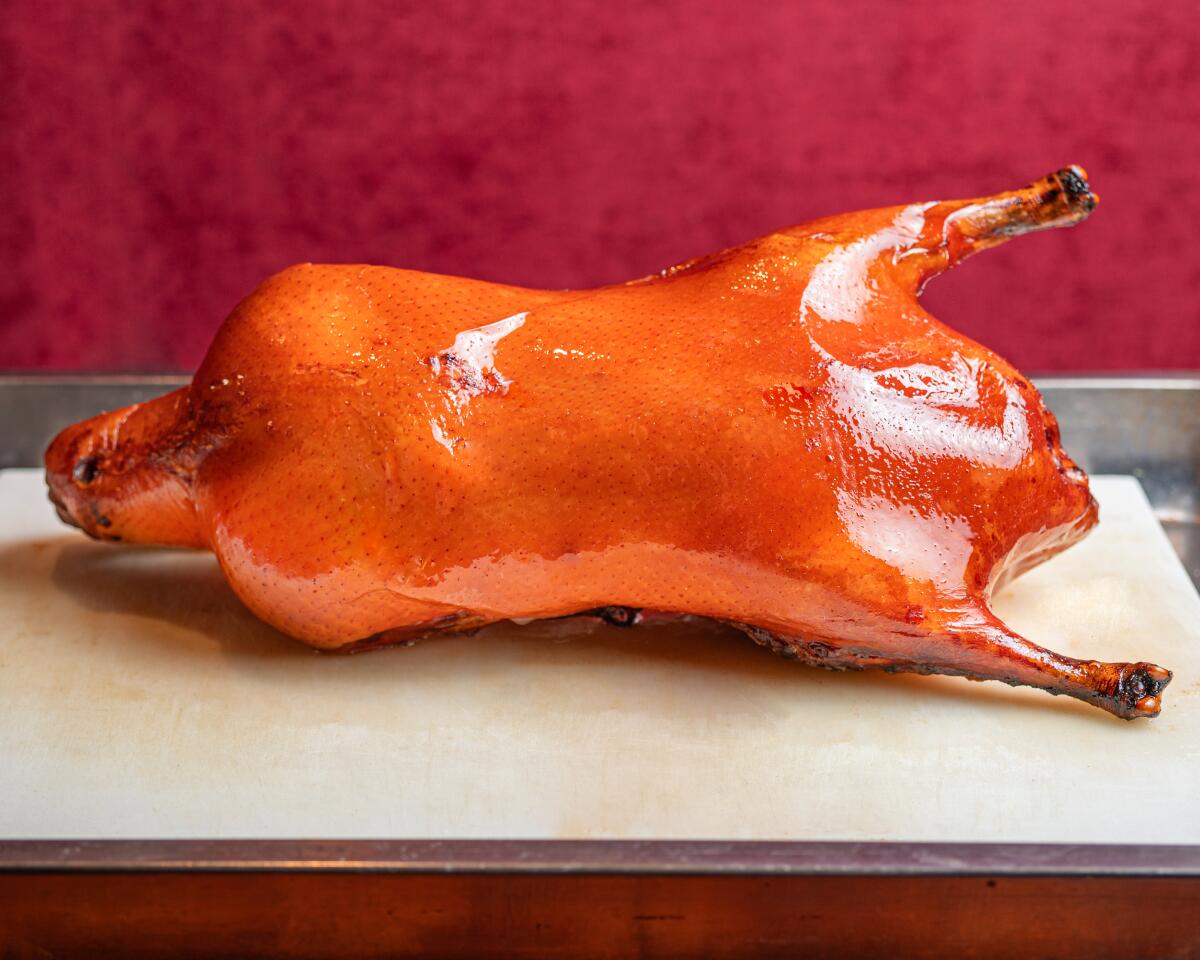 A glossy cooked duck on a counter
