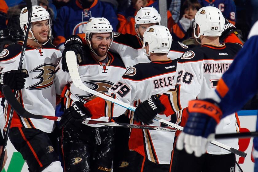The Ducks celebrate a second-period goal by Kyle Palmieri, second left, during a 3-2 victory over the New York Islanders on Saturday.