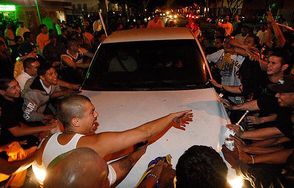 Unruly fans block traffic at the intersection of Pico Boulevard and Hope Street after the Lakers' NBA championship victory over the Celtics.